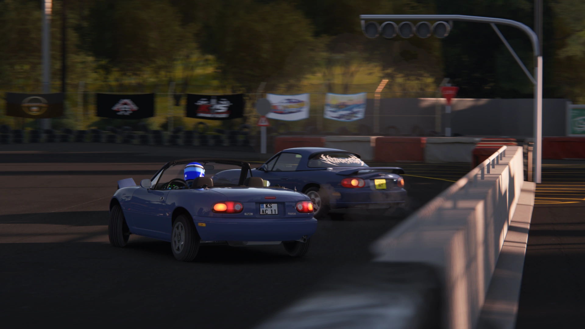 Miatas tandem drifting past the starting semaphore